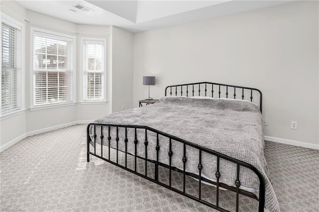 bedroom featuring visible vents, baseboards, and carpet