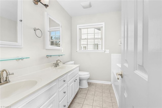 full bathroom with tile patterned flooring, toilet, baseboards, and a sink