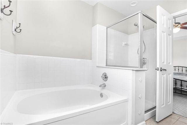 full bath featuring ensuite bath, tile patterned floors, a garden tub, and a shower stall