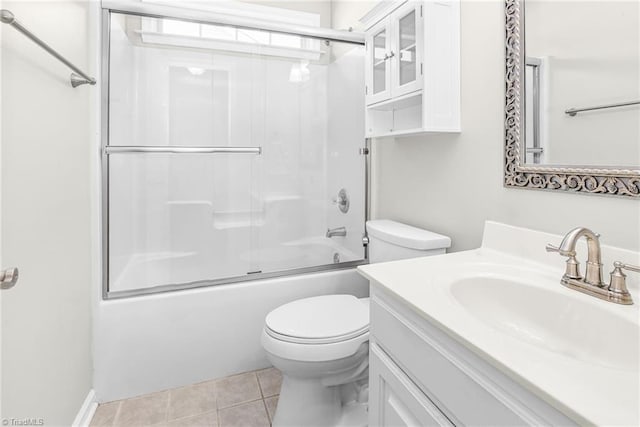 full bathroom with tile patterned floors, toilet, vanity, and shower / bath combination with glass door