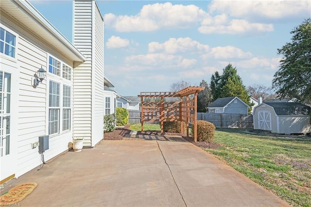 view of patio / terrace with a shed, a pergola, an outdoor structure, and fence