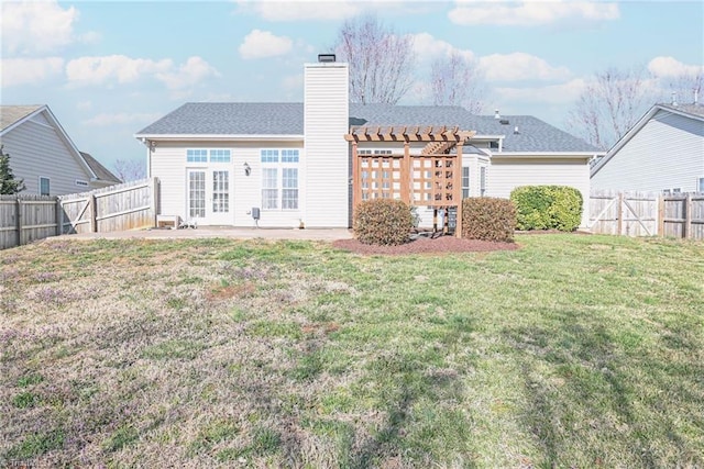 back of house with a lawn, a chimney, a fenced backyard, a pergola, and a patio