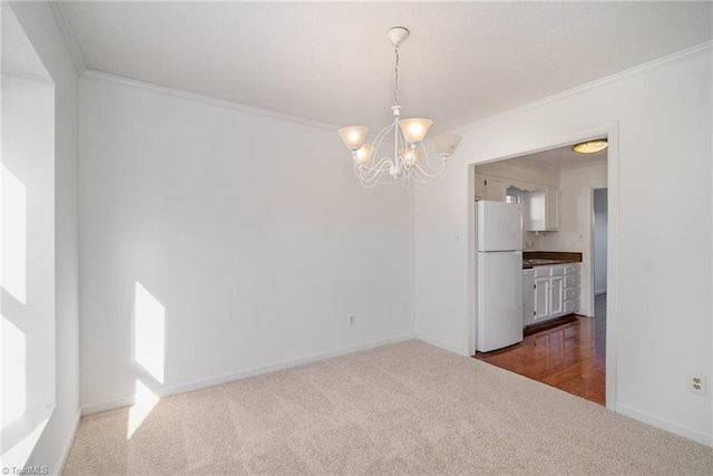 empty room with ornamental molding, a chandelier, and dark colored carpet