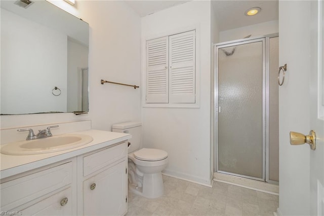 bathroom featuring vanity, an enclosed shower, and toilet