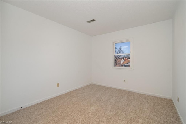 unfurnished room with light colored carpet