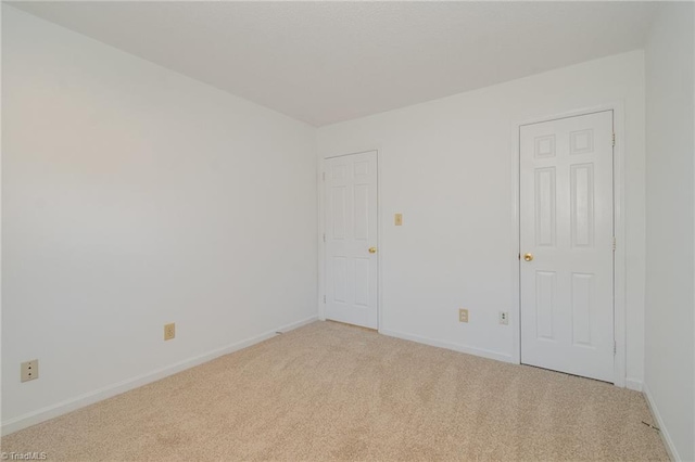 spare room with light carpet