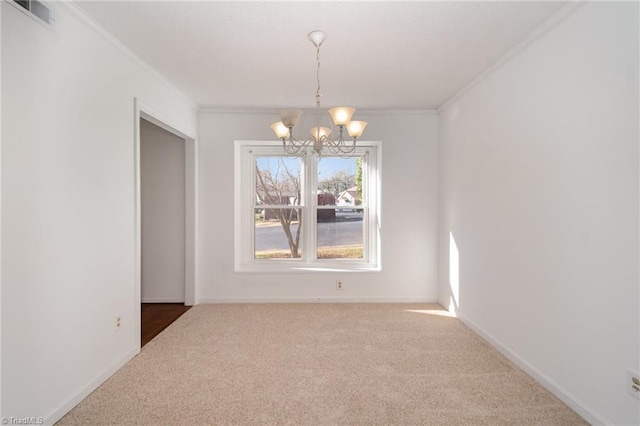 unfurnished dining area with ornamental molding, carpet floors, and a chandelier