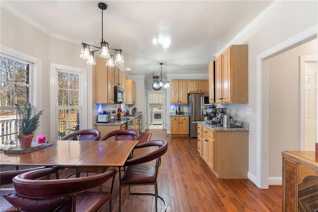 kitchen featuring crown molding, dark wood-style flooring, backsplash, and stainless steel appliances