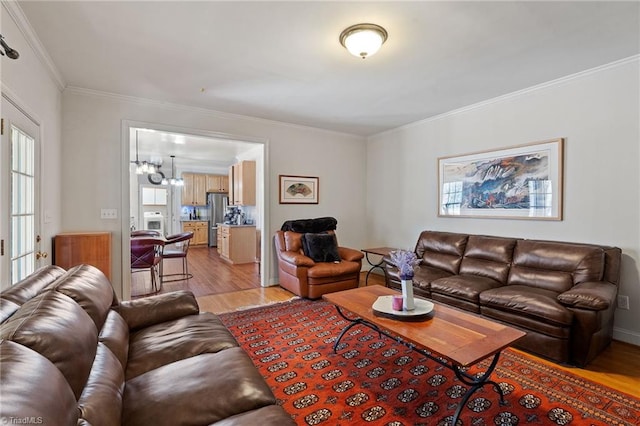 living room with light wood-style floors and crown molding