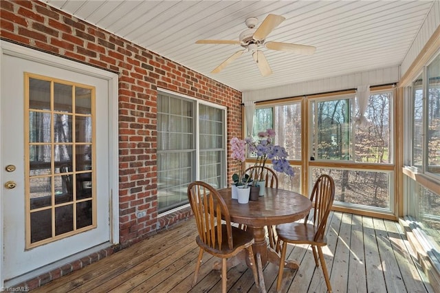 sunroom featuring a wealth of natural light and a ceiling fan