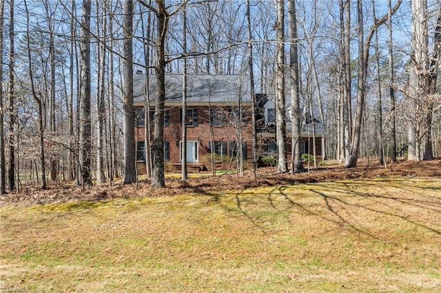 exterior space with a lawn and brick siding