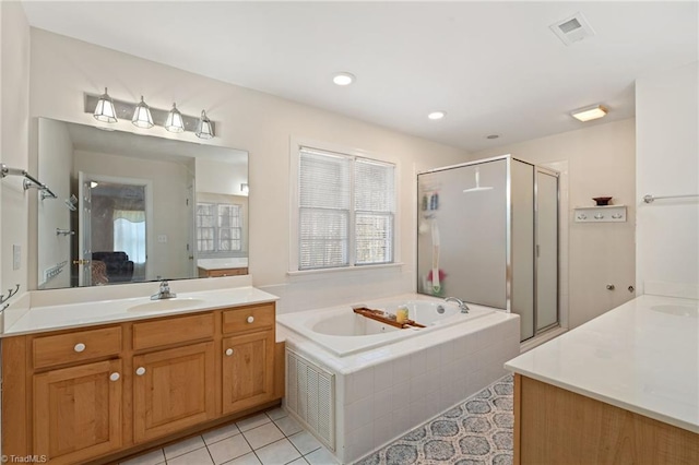 bathroom featuring visible vents, a stall shower, vanity, and a bath