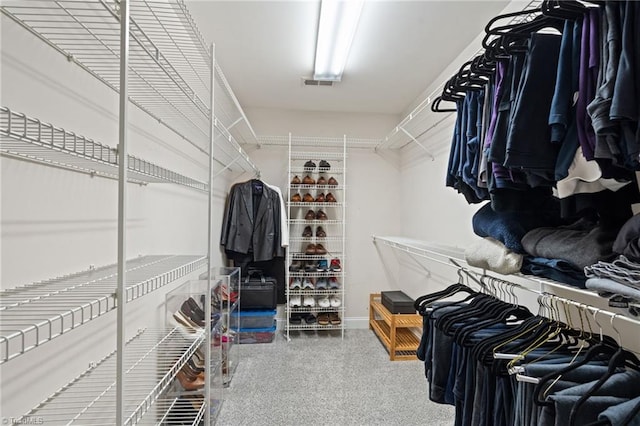 walk in closet featuring visible vents and carpet floors