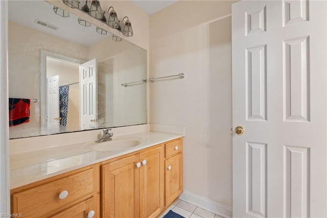 bathroom featuring tile patterned floors, visible vents, baseboards, and vanity