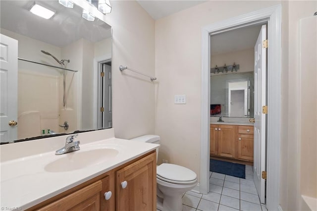 bathroom featuring vanity, tile patterned floors, toilet, and a shower