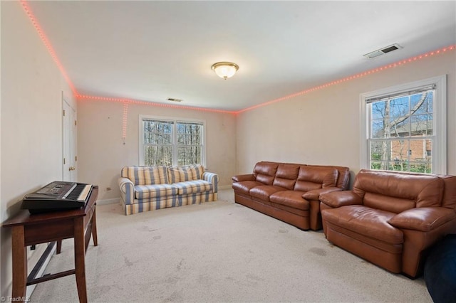 carpeted living room featuring baseboards, visible vents, and ornamental molding