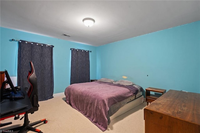 carpeted bedroom featuring visible vents