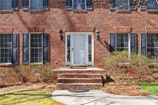 entrance to property with brick siding