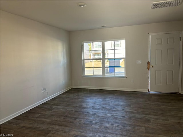 unfurnished room featuring dark hardwood / wood-style flooring