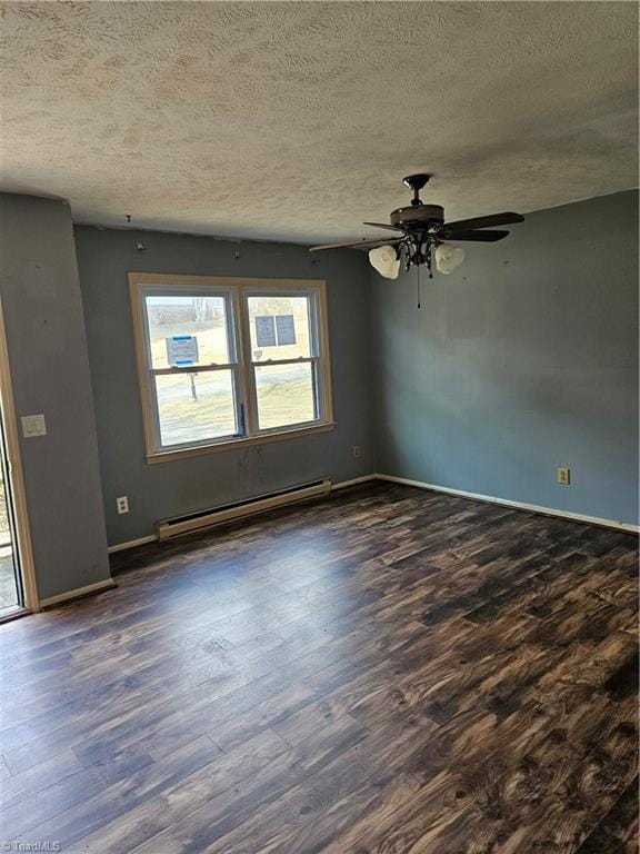 spare room featuring dark wood-style floors, baseboards, and a baseboard radiator