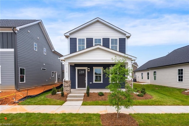 view of front of home with a porch and a front lawn