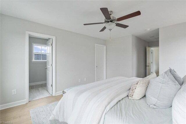 bedroom with ceiling fan, light wood-type flooring, and baseboards