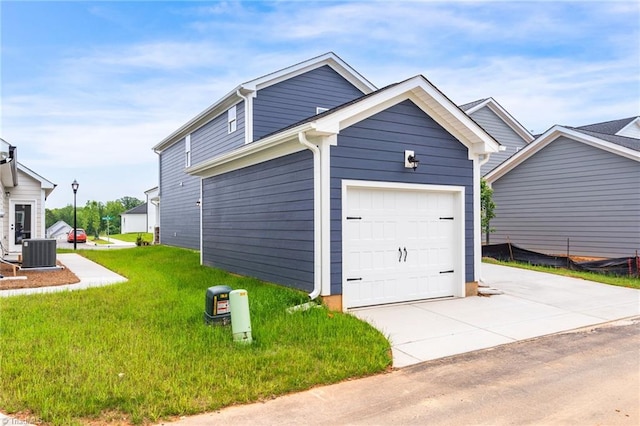 exterior space with a garage, driveway, a lawn, and cooling unit