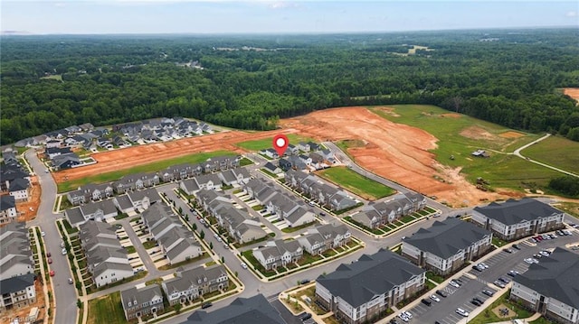 aerial view featuring a forest view and a residential view