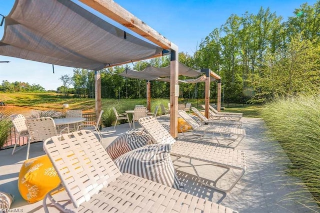 view of patio featuring outdoor dining area and a pergola