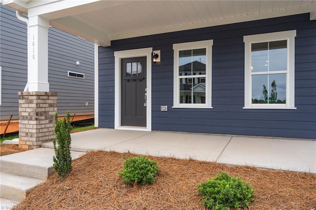 doorway to property featuring covered porch