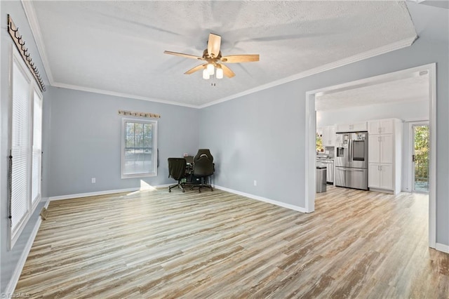 interior space featuring light hardwood / wood-style floors, ornamental molding, a textured ceiling, and ceiling fan