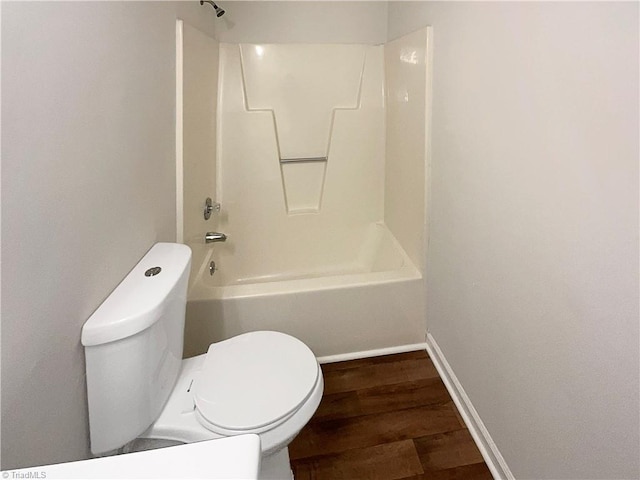 bathroom with toilet, shower / bath combination, and hardwood / wood-style floors