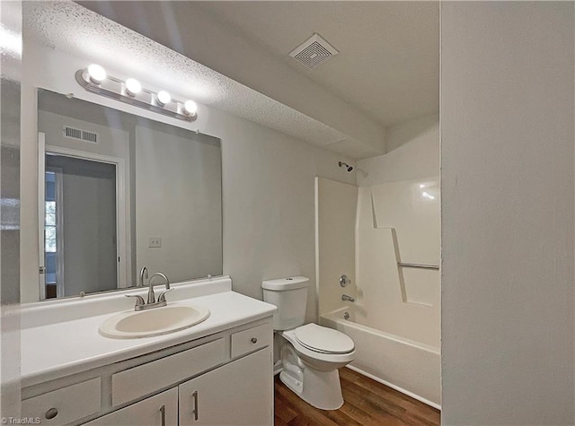 full bathroom with vanity, toilet, bathtub / shower combination, and hardwood / wood-style floors