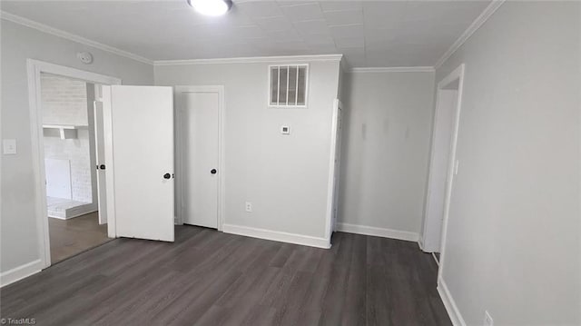 unfurnished bedroom featuring a closet, crown molding, and dark hardwood / wood-style flooring