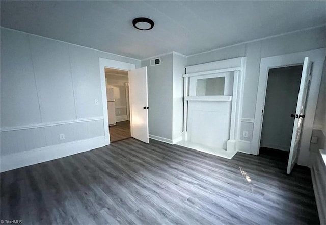 unfurnished bedroom featuring a closet and dark hardwood / wood-style floors