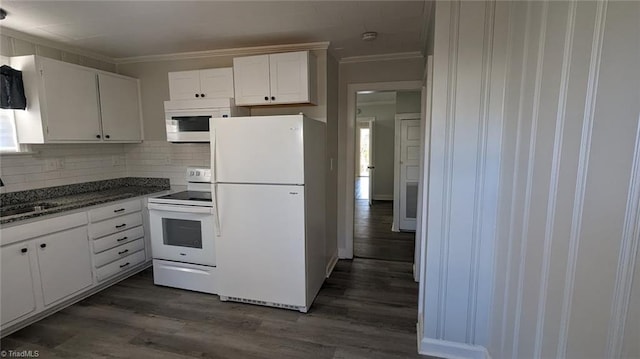 kitchen with tasteful backsplash, white cabinets, white appliances, crown molding, and dark hardwood / wood-style floors