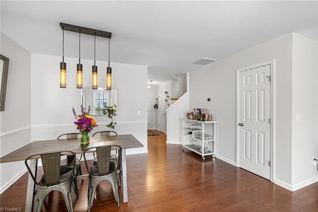 3719 Spanish Peak Dr, High Point, NC 27265 - dining area with wood finished floors, stairway, and baseboards