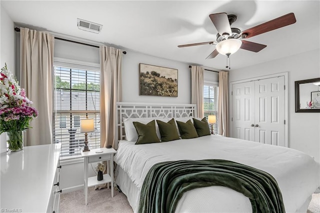 3719 Spanish Peak Dr, High Point, NC 27265 - bedroom with light colored carpet, a closet, and a ceiling fan