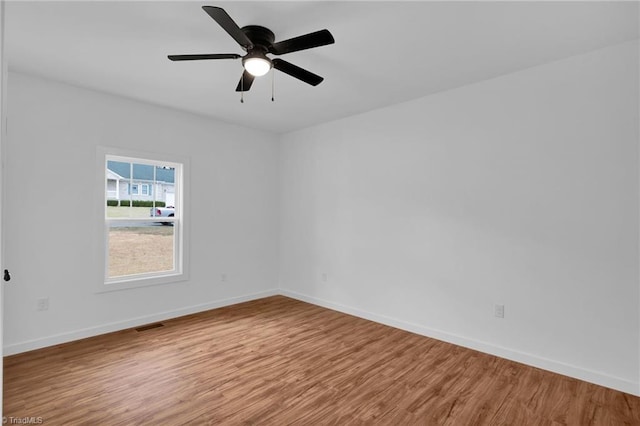 spare room with hardwood / wood-style floors and ceiling fan