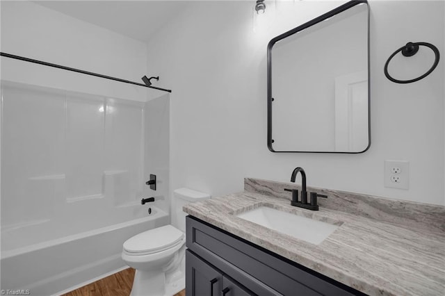 full bathroom with hardwood / wood-style floors, vanity, toilet, and shower / bathing tub combination