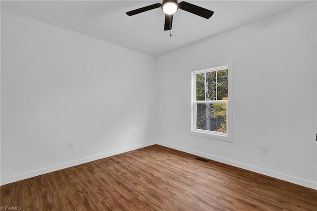 empty room with hardwood / wood-style flooring and ceiling fan