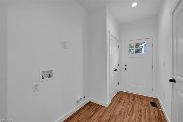 clothes washing area featuring hookup for a washing machine, electric dryer hookup, and hardwood / wood-style flooring