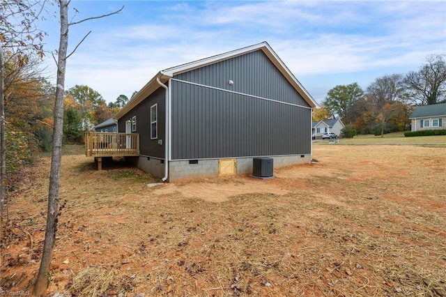 view of side of property with cooling unit and a deck