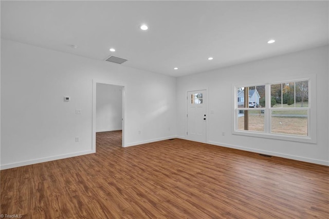 unfurnished room with wood-type flooring