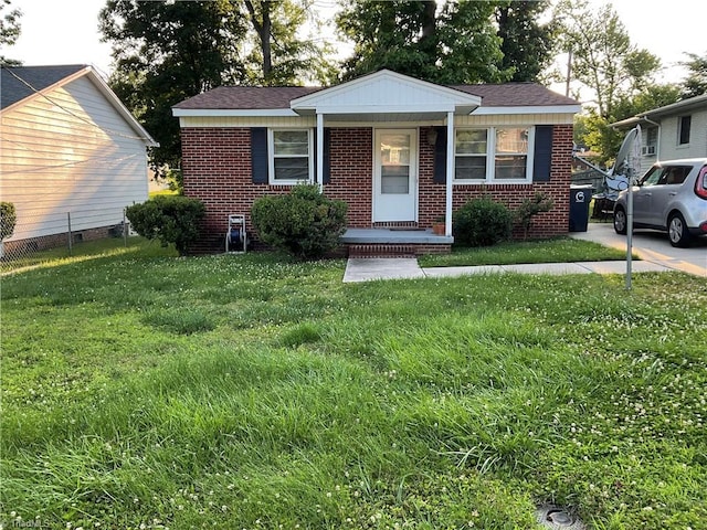 1706 Alice Ave, Greensboro, NC 27401 - bungalow-style house featuring brick siding, a front lawn, and covered porch