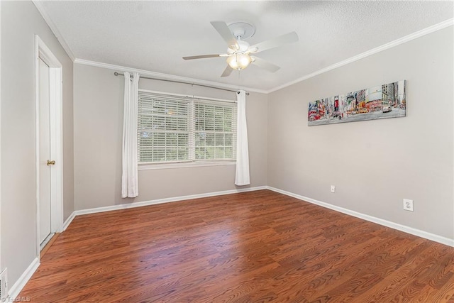 spare room featuring a ceiling fan, wood finished floors, crown molding, baseboards, and a textured ceiling