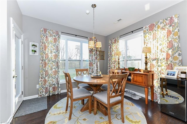 dining space featuring dark hardwood / wood-style flooring and a wealth of natural light