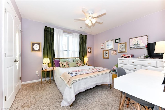 bedroom featuring light colored carpet and ceiling fan