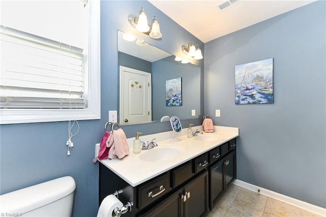 bathroom with tile patterned floors, vanity, and toilet