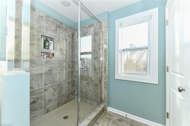 bathroom with tile patterned floors and a shower with shower door